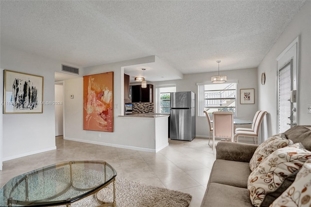 tiled living room with a textured ceiling