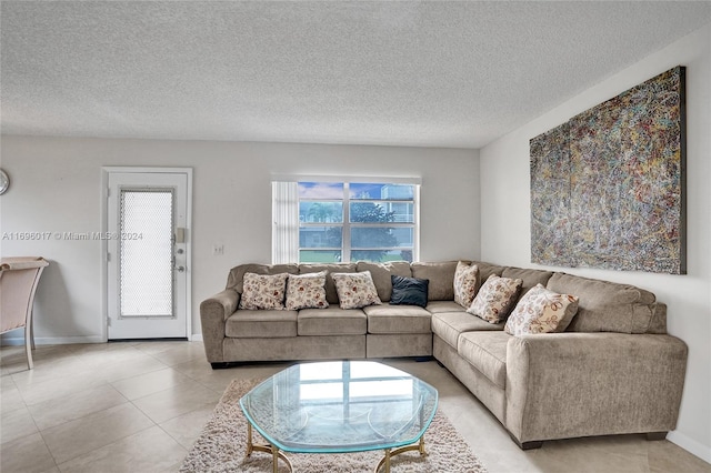 tiled living room featuring plenty of natural light and a textured ceiling