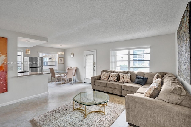 tiled living room with a textured ceiling