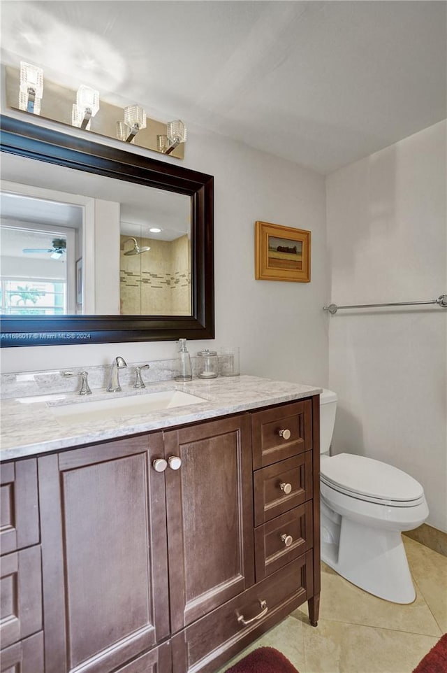 bathroom with tile patterned floors, walk in shower, vanity, and toilet