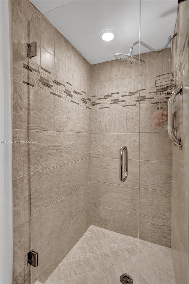 bathroom with a shower with shower door