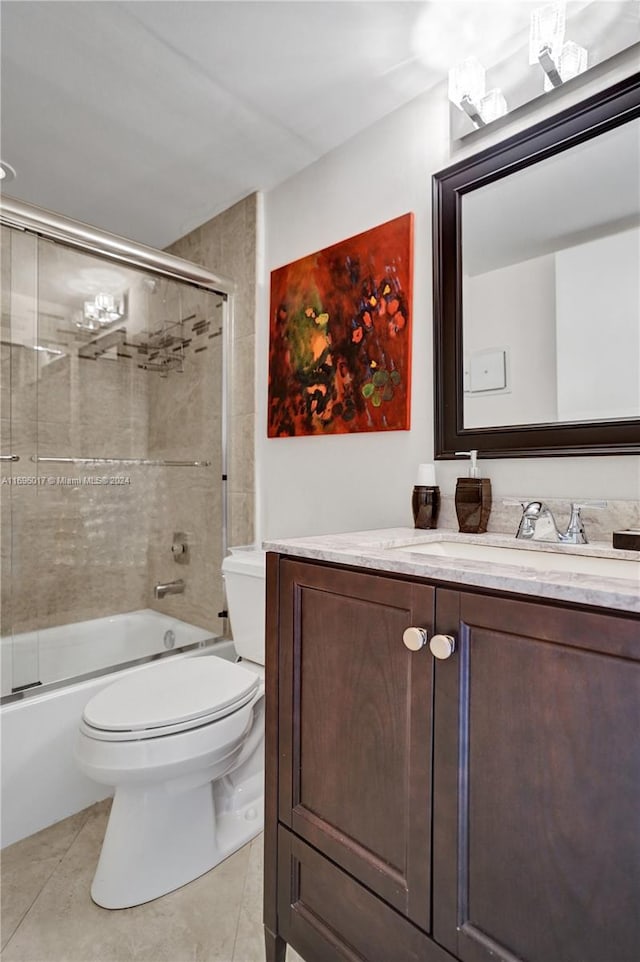 full bathroom featuring tile patterned floors, vanity, toilet, and enclosed tub / shower combo