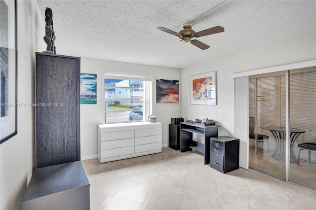 home office featuring a textured ceiling and ceiling fan