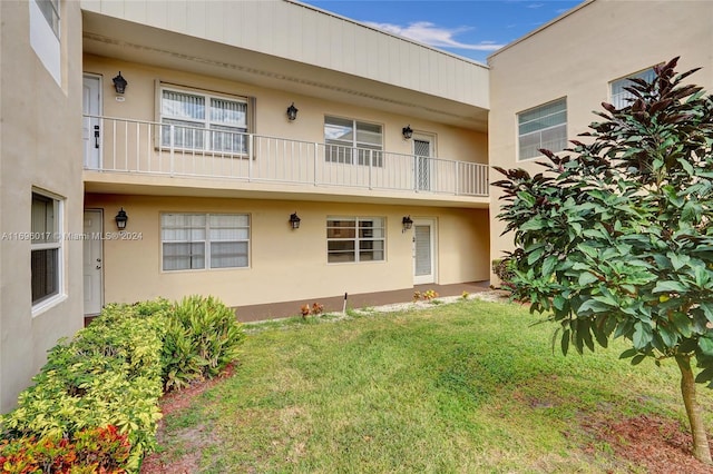 rear view of property with a lawn