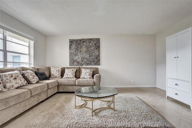 living room with tile patterned flooring and a textured ceiling