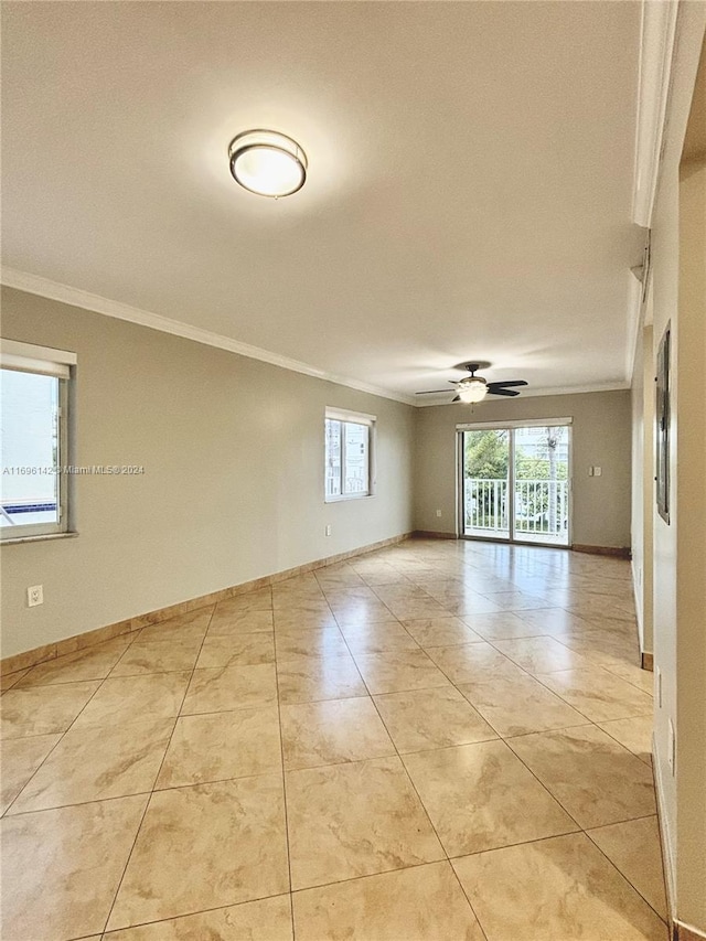 empty room featuring ceiling fan, light tile patterned floors, and ornamental molding