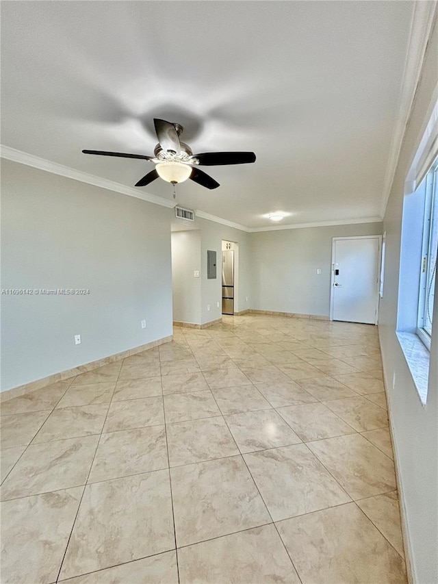 spare room featuring electric panel, ceiling fan, and crown molding