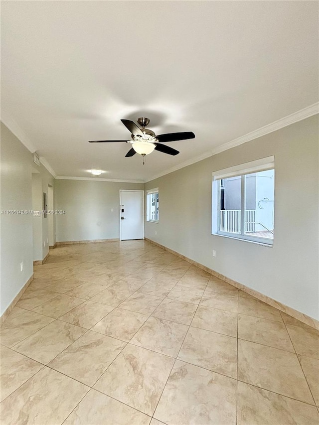 unfurnished room with ceiling fan and crown molding