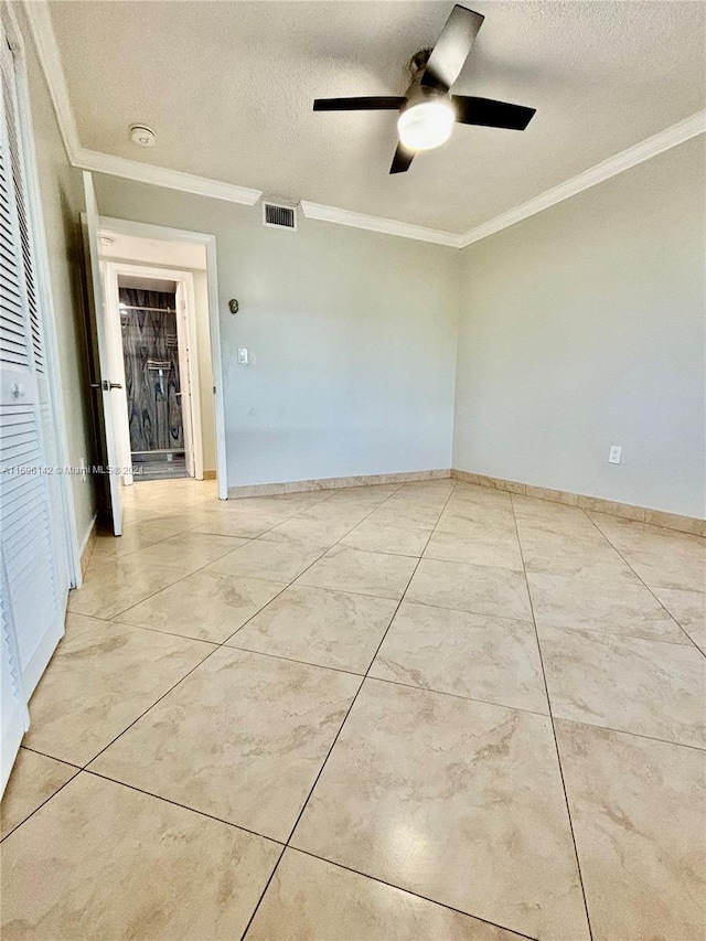 spare room with ceiling fan, a textured ceiling, and ornamental molding