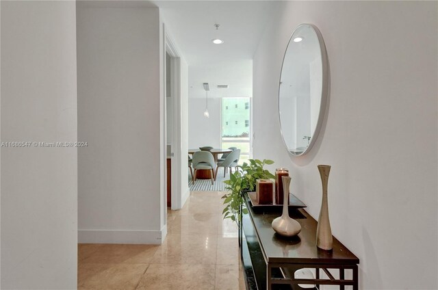 hallway featuring light tile patterned flooring