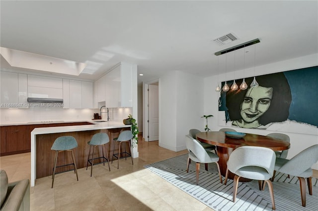 tiled dining area featuring sink