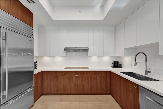 kitchen featuring ventilation hood, stainless steel appliances, white cabinetry, and sink