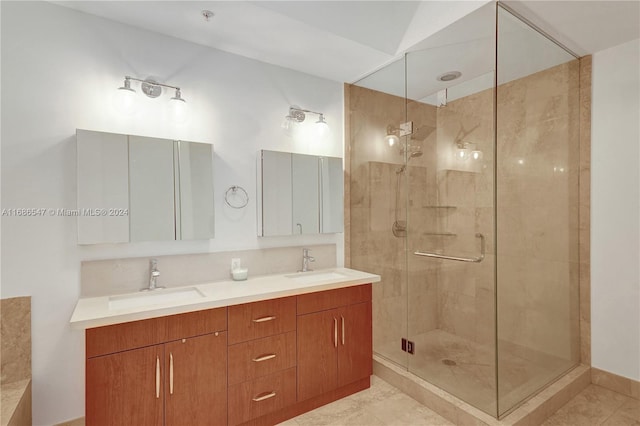 bathroom featuring tile patterned flooring, vanity, and walk in shower