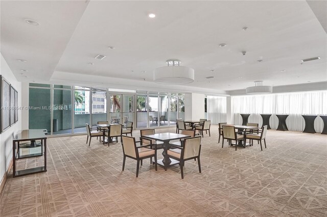 dining space featuring a tray ceiling