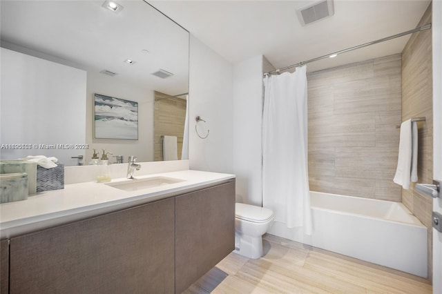 full bathroom with vanity, toilet, shower / bathtub combination with curtain, and wood-type flooring