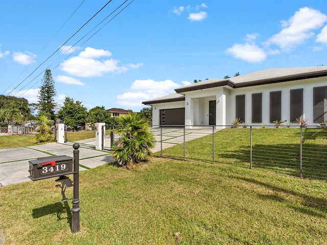 view of front facade with a garage and a front yard