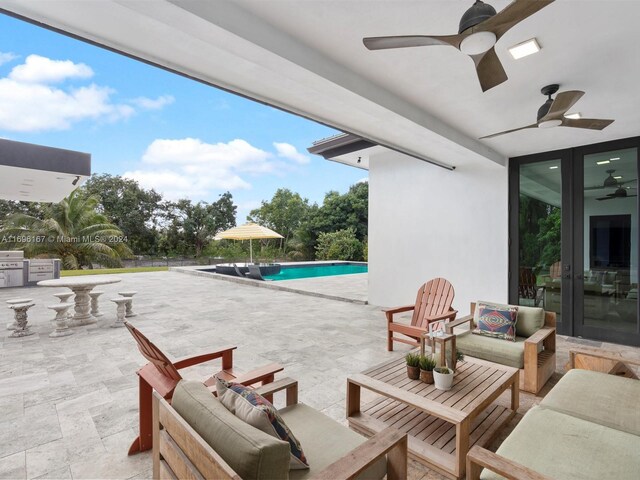 view of patio / terrace featuring french doors, an outdoor living space, and ceiling fan