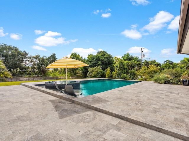 view of pool with a patio area and an in ground hot tub