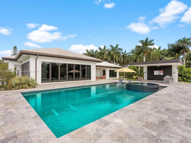 view of swimming pool featuring an in ground hot tub and a patio