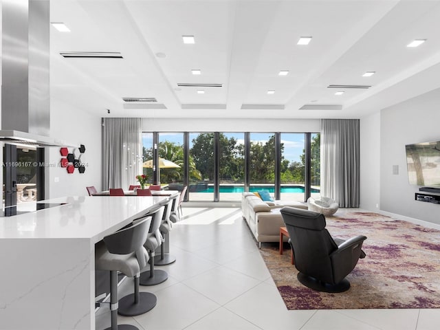 tiled living room featuring beamed ceiling and a healthy amount of sunlight