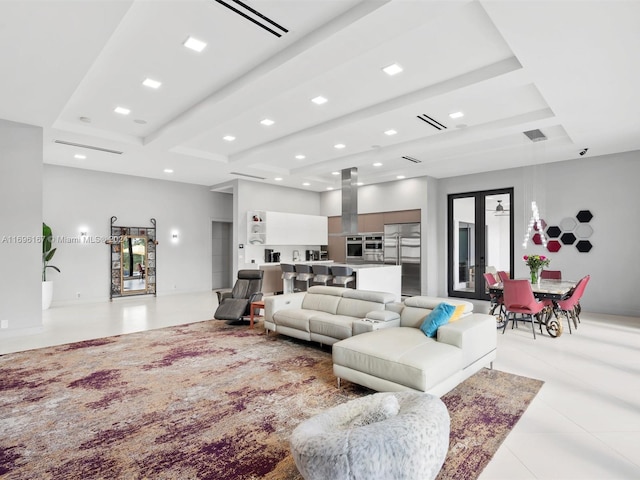 living room with beam ceiling and light tile patterned floors