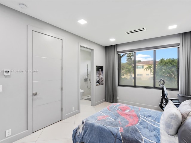 bedroom featuring ensuite bath and light tile patterned flooring