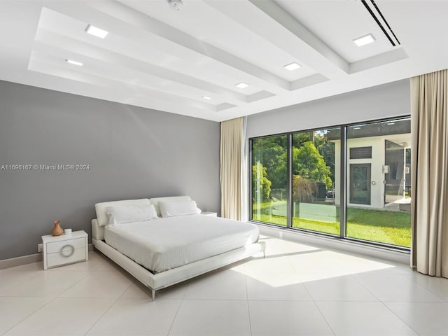 bedroom with beamed ceiling and light tile patterned flooring