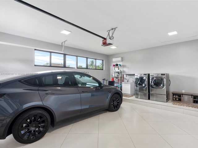 garage featuring washing machine and dryer and a garage door opener