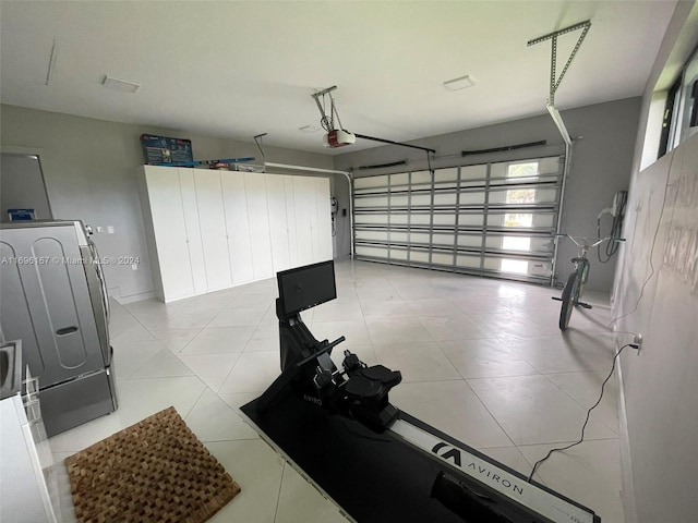 garage with washer / clothes dryer and a garage door opener