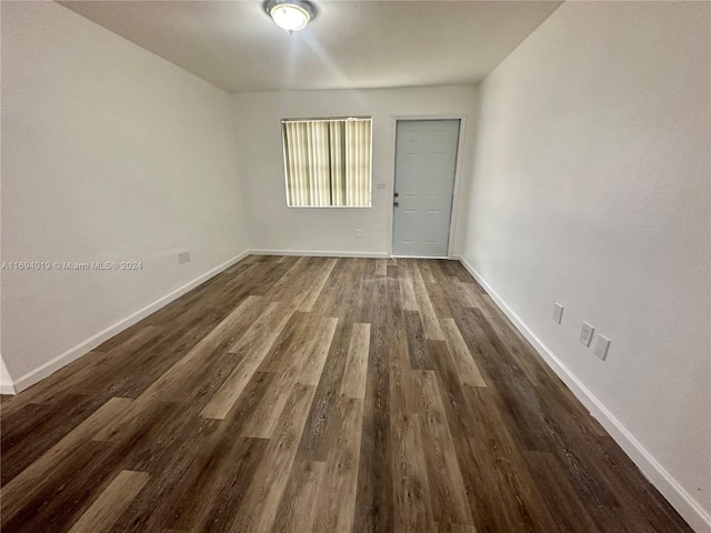 spare room with dark wood-type flooring