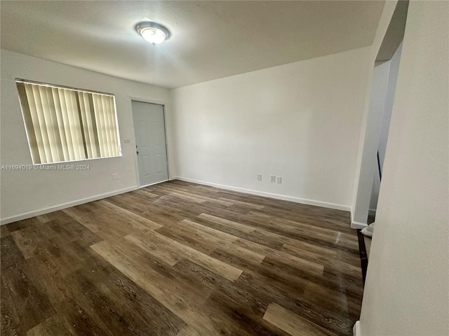 spare room with dark hardwood / wood-style floors