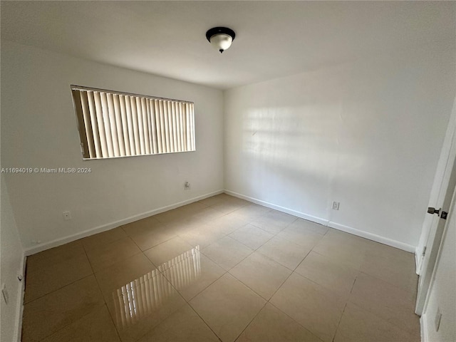 empty room featuring light tile patterned floors