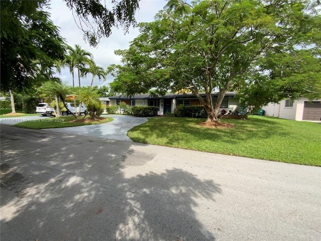 ranch-style home with a front lawn