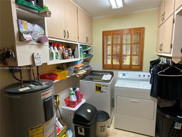 clothes washing area featuring washing machine and dryer, electric water heater, light tile patterned flooring, and cabinets