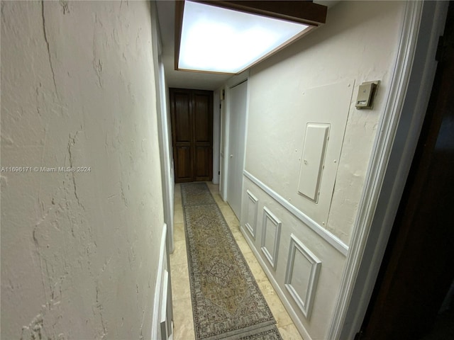 hall with light tile patterned floors