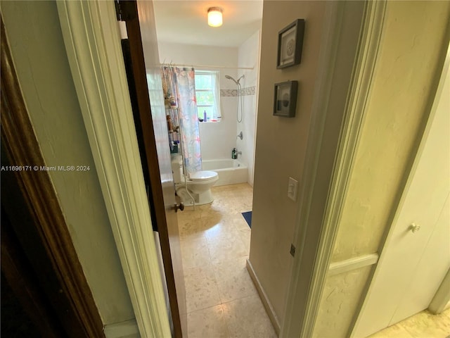 bathroom featuring toilet and shower / bath combo with shower curtain