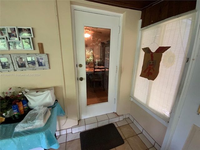 doorway with light tile patterned flooring