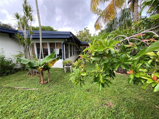 view of yard featuring a sunroom