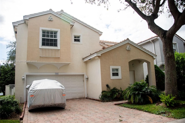 mediterranean / spanish house with a garage