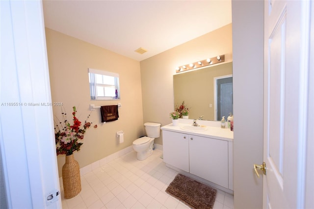 bathroom with tile patterned floors, vanity, and toilet