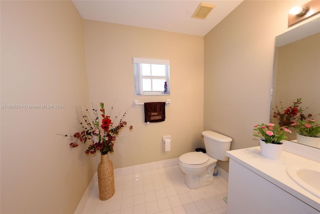 bathroom featuring tile patterned floors, vanity, and toilet