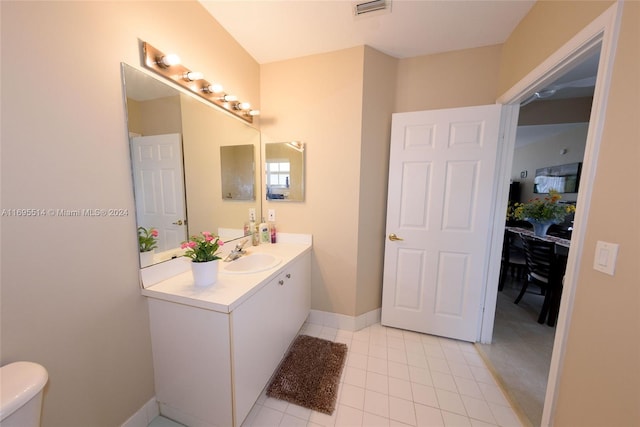 bathroom featuring tile patterned flooring, vanity, and toilet