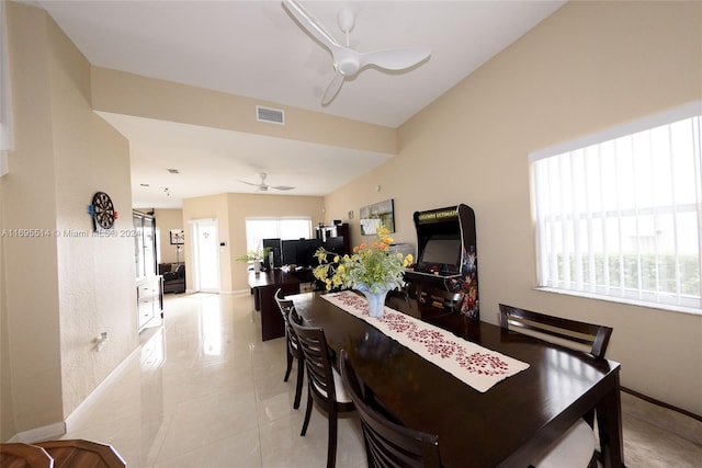 dining area featuring a wealth of natural light, ceiling fan, and light tile patterned flooring