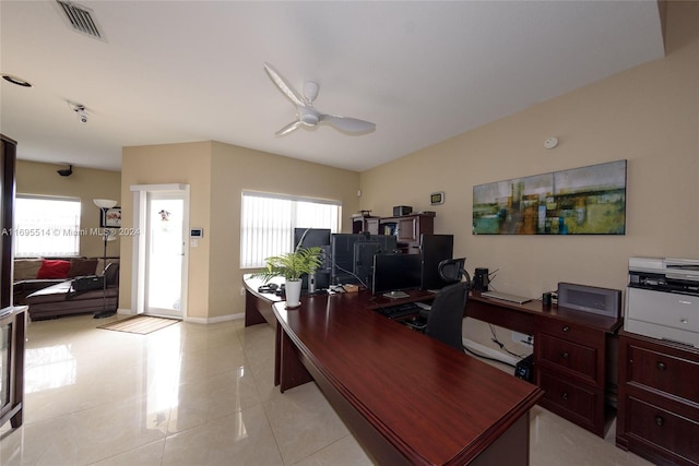 tiled office space featuring ceiling fan and a healthy amount of sunlight