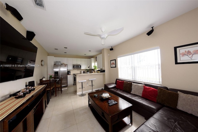 living room with ceiling fan and light tile patterned floors