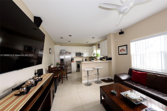 living room with light tile patterned floors and ceiling fan