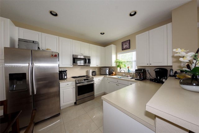 kitchen with white cabinetry, sink, light tile patterned floors, and stainless steel appliances