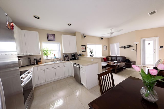 kitchen featuring kitchen peninsula, white cabinetry, sink, and stainless steel appliances