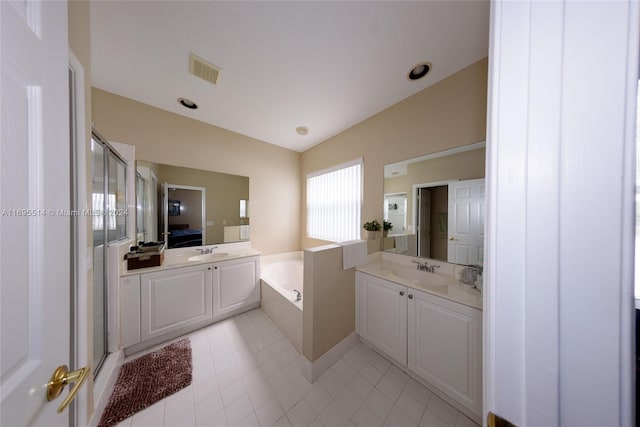 bathroom with tile patterned floors, vanity, shower with separate bathtub, and vaulted ceiling