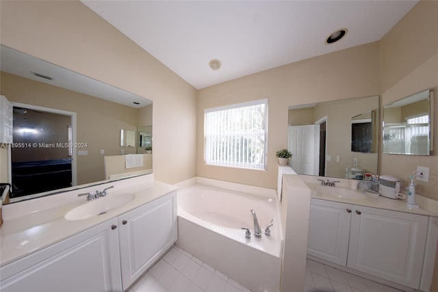 bathroom with vanity, tile patterned floors, and a tub